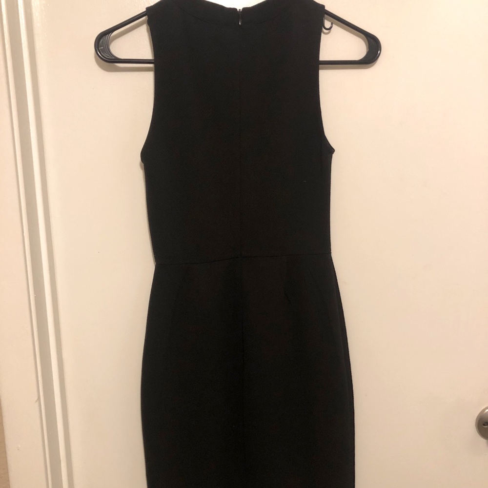 Tight fitted black high neck dress.